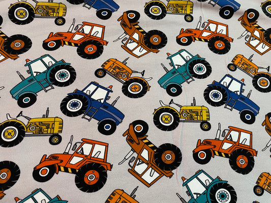 Multicoloured tractors on grey